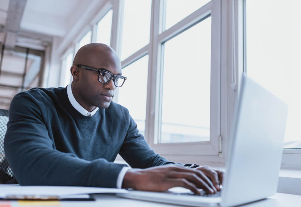 A man looking at his computer.
